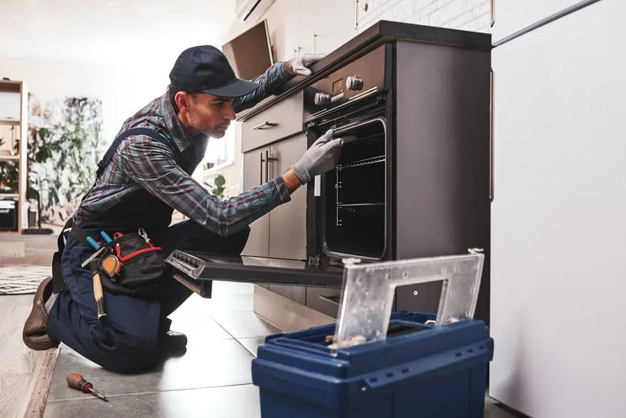technician repairing an oven