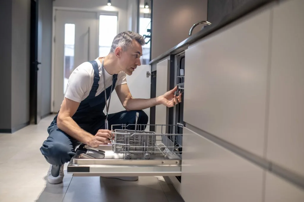 repair-technician-working-on-a-washing-machine